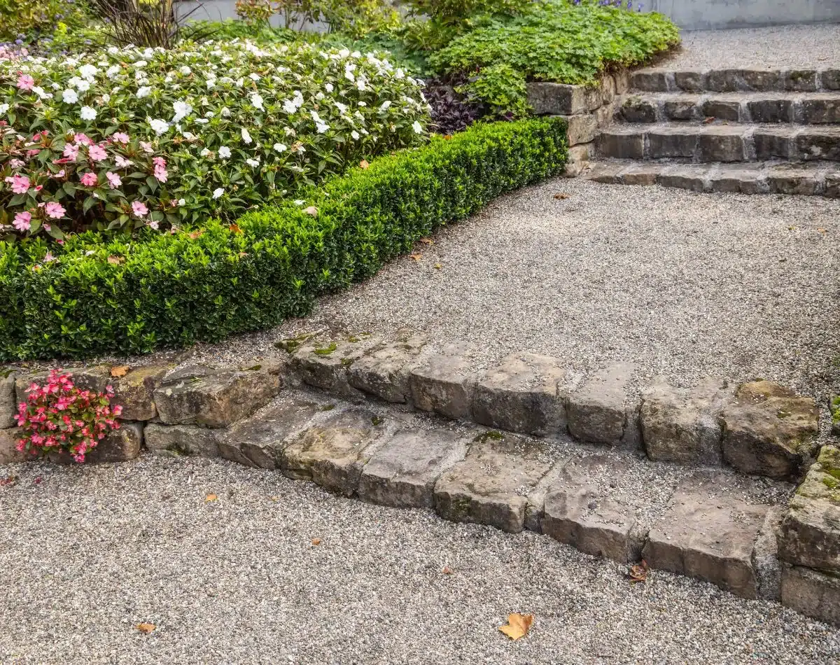 Natural stone steps and landings integrated into a retaining wall
