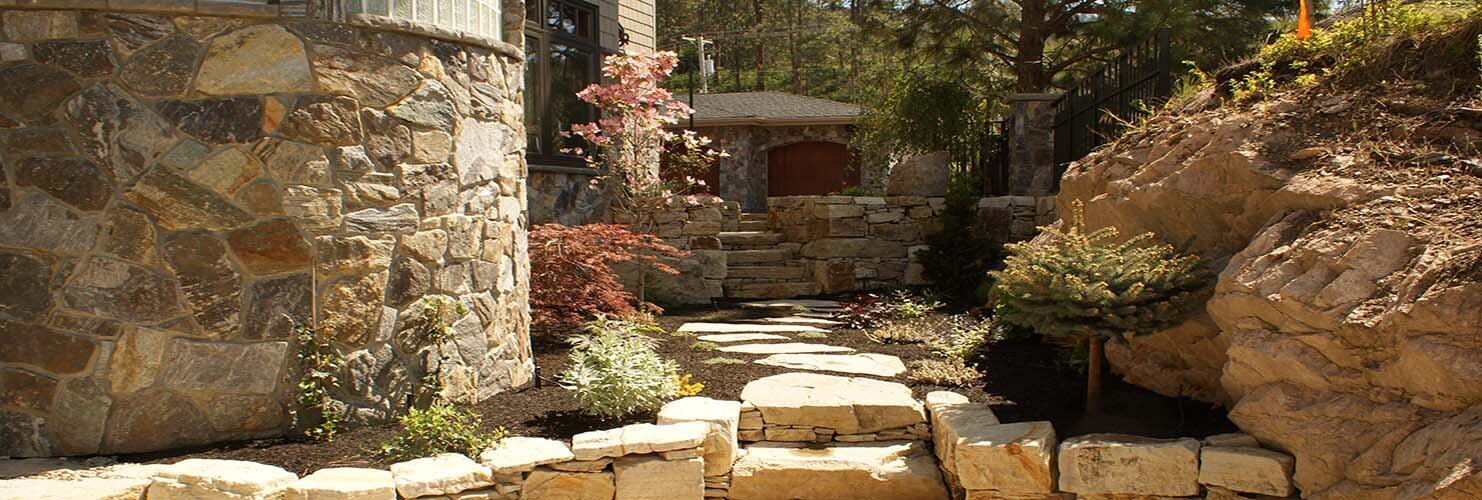 Stacked block retaining wall holding a slope